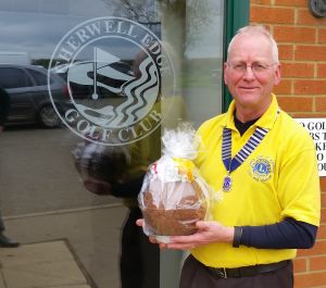 Lion President Phil with an Easter Egg, raffled by Cherwell Edge Golf Club