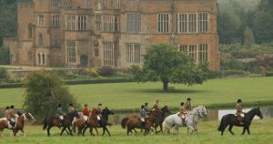 Riders passing by Broughton Castle at the start of the ride